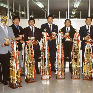 左からタイガーマスク、木村健吾、藤波辰巳、ジャンボ鶴田、長州力、アントニオ猪木、天龍源一郎、山田恵一